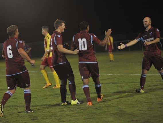 Wes Tate (number 10) is congratulated after scoring one of his four goals for Little Common against Lingfield. Picture by Simon Newstead
