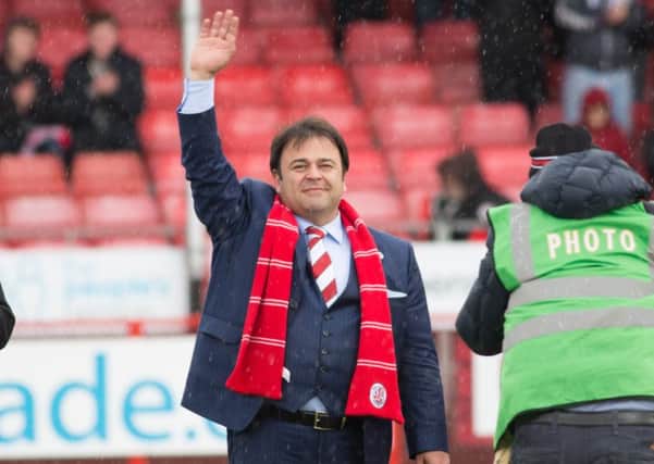 New owner Ziya Eren waves to Crawley Town fans before their game against Oxford United, 9th April 2016. (c) Jack Beard SUS-160904-185403008