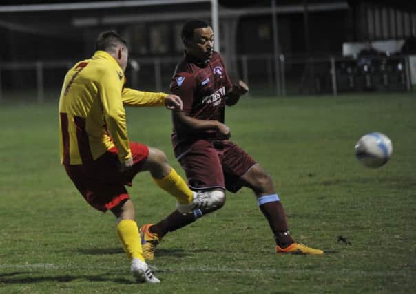 Wes Tate closes down a Lingfield opponent at the Recreation Ground on Tuesday night. Picture by Simon Newstead