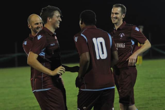 Wes Tate is congratulated by Russell Eldridge, Dom Bristow and Lewis Hole after scoring one of his four goals against Lingfield. Picture by Simon Newstead