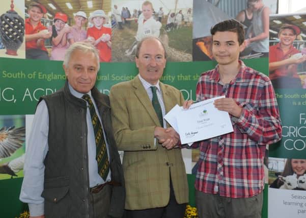 Student Kaine Marshall with judge Des Lambert, left, and South of England Agricultural Society president Charles Moore