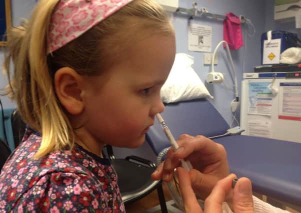 Four-year-old Grace Whitehead receives the flu vaccine