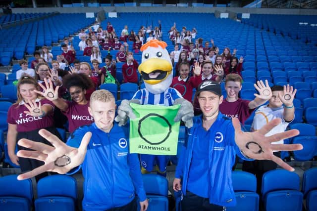 I AM WHOLE NHS Campaign - students from secondary schools and colleges from the county, as well as members of Brighton & Hove  Youth Council, gather at the AMEX Stadium in support of the campaign. Pictured with (front, l to r) B&H Albion U21's Henrik Bjordal, Gully, and Vahid Hambo. SUS-160710-130646001