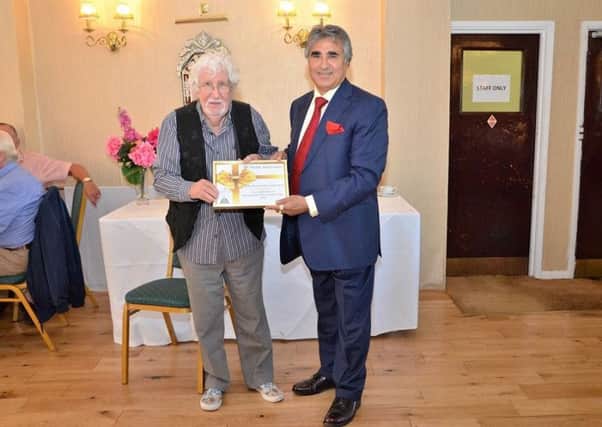Ian Harrison, 81, one of 20 older people selected for a free afternoon tea  to celebrate the achievements of older people, and Eastbourne Pier owner Sheikh Abid Gulzar SUS-161110-120422001