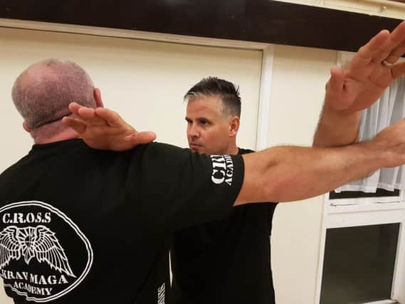 Sean Clark (right) who came up with the idea for the class, practicing Cross Krav Maga