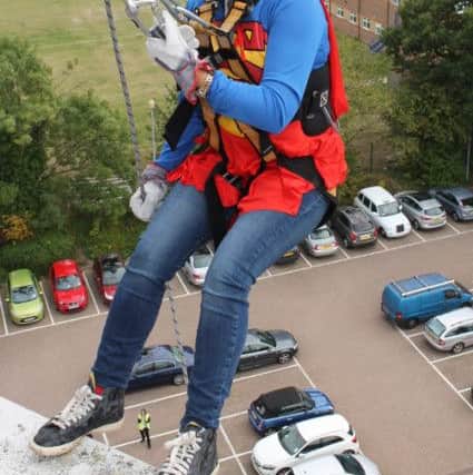 St Catherine's Hospice superhero abseilers at the Sandman Signature Hotel in Crawley - picture credit Richard Lycett Photography