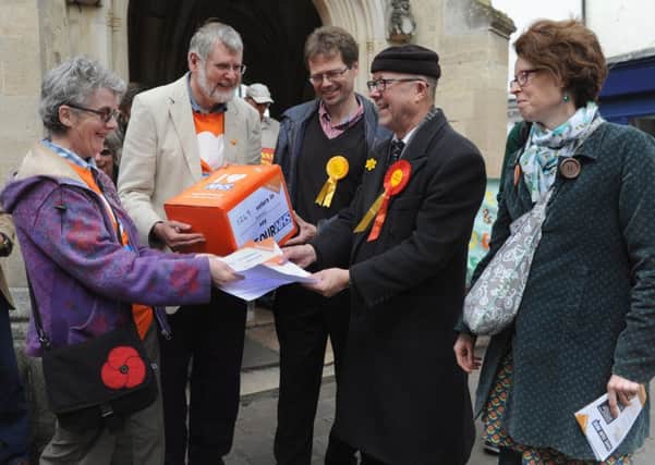Jan Birtwell (left) of 38 Degrees handing over the petition to local candidates last year is one of three signatures  of a stinging open letter of Sustainability and Transformation Plans