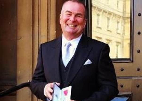 Peter Chisholm with his MBE SUS-161013-154120001