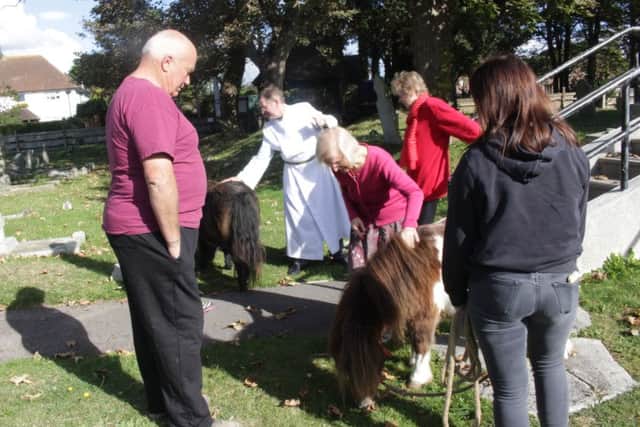 Nigel Mundy from Pagham Ponies, left, gives the congregation the chance to meet the animals after the annual pets' service