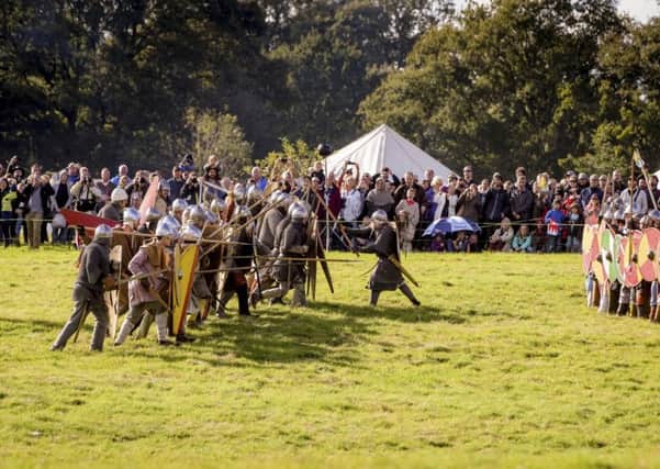 Norman and Saxon forces clash in front of visitors at last year's annual Battle of Hastings re-enactment. Picture by Jim Holden. Â© English Heritage Trust