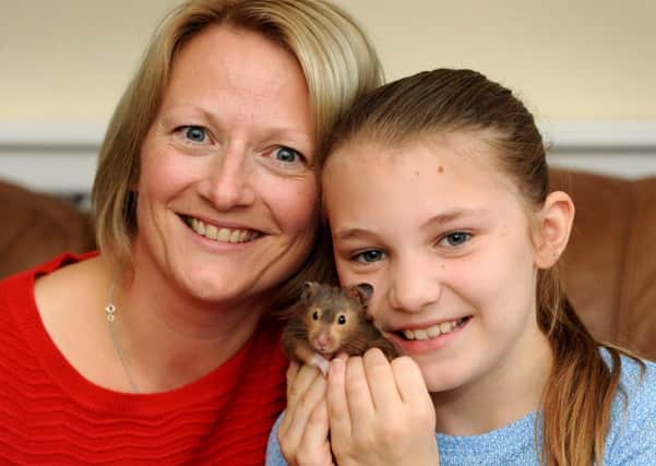 Mum Kate with Eva and Eva's 'best friend' hank the hamster
