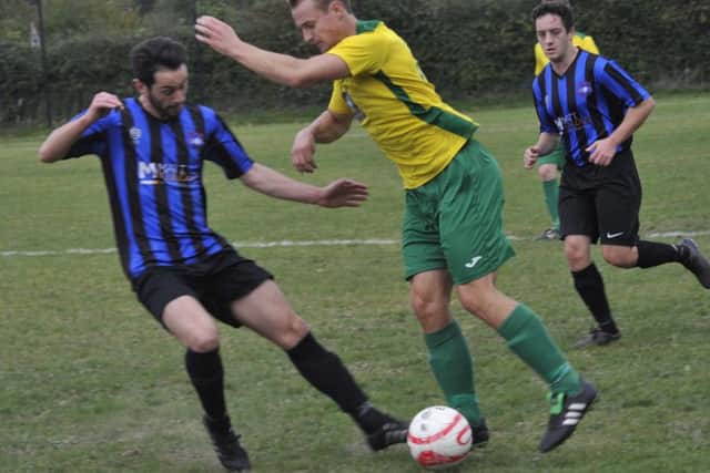 Sam Ellis tussles with a Worthing Town Leisure opponent.