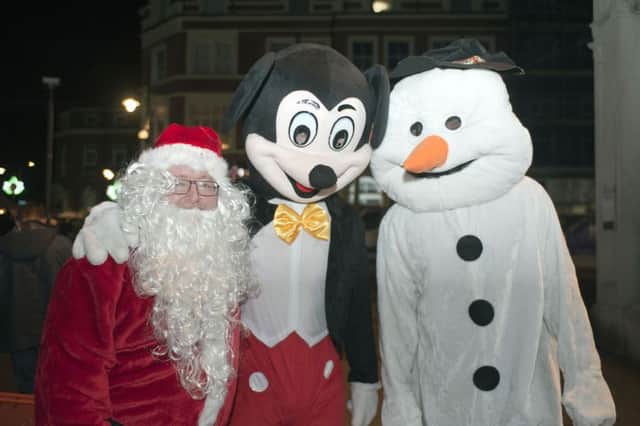 Shining Lights managing director Michael Matthews as Santa Claus and his son David as Mickey Mouse at last years Christmas Extravaganza. Photo by Frank Copper SUS-150512-105125001