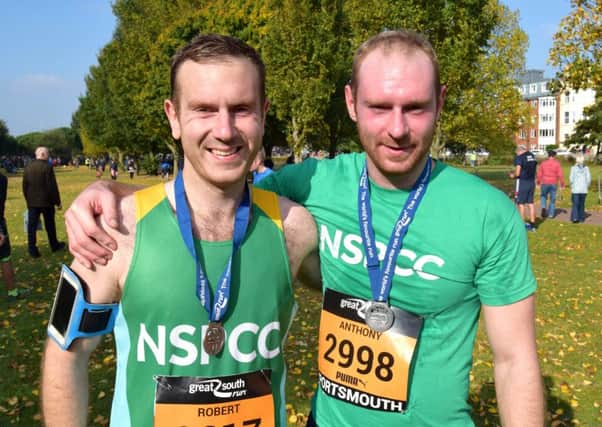 Brothers Rob Dunne (left) and Anthony Dunne after crossing the line together