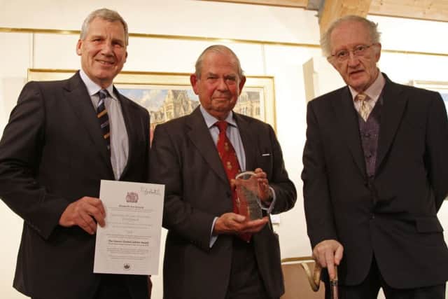 The Queens Award for Voluntary Services is presented to the Community Minibus Association (West Sussex). Left to right: Alistair Sheppard, Sir Brian Barttelot, Rodger Hunt