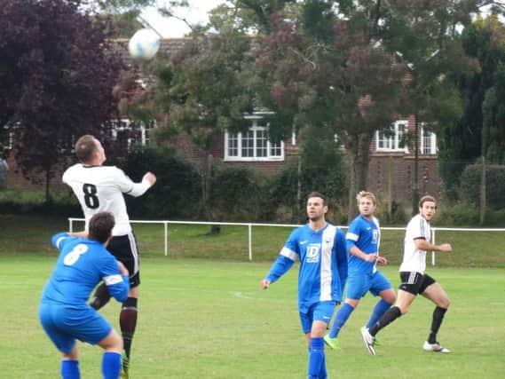Gordon Cuddington wins a header during Bexhill United's 3-1 defeat away to Storrington on Saturday. Picture courtesy Mark Killy