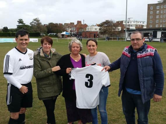 Bexhill United full-back Craig Ottley (left) with the family of the late Richard Dickie Anderson at The Polegrove. Picture courtesy Mark Killy