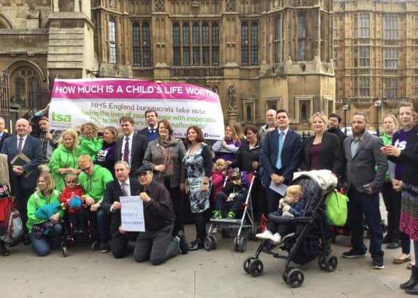 Lottie Norton, Ed Usher and their son Freddie with Huw Merriman MP and campaigners outside Parliament SUS-161027-131157001