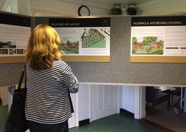 Resident viewing the plans for 50 homes in Bosham