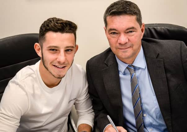 Conor Chaplin signs his new Pompey deal in the presence of chief executive Mark Catlin Picture: Colin Farmery