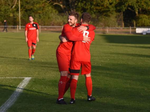 Michael Death celebrates with goalscorer Nathan Miles. Action from Hassocks v Worthing United. Picture by Phil Westlake