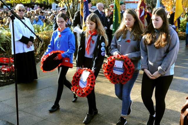 Girls laying poppy wreaths at the Remembrance Sunday service in Burgess Hill. Picture: Steve Robards