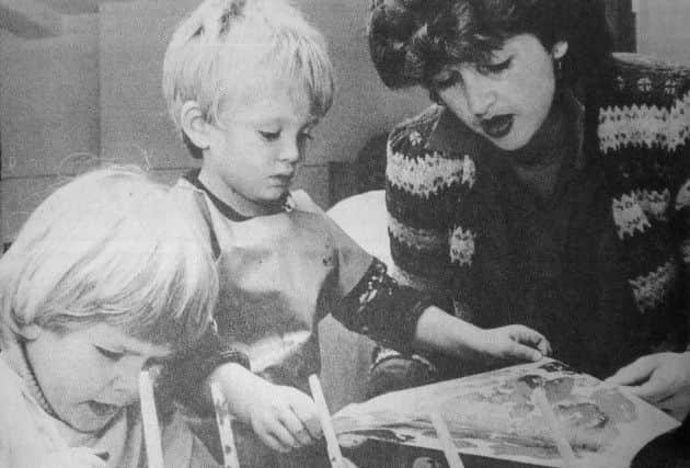 Volunteer worker Jill Prince helps young artists James and Paul at Windows Opportunity Playgroup in 1984 SUS-161026-160345001