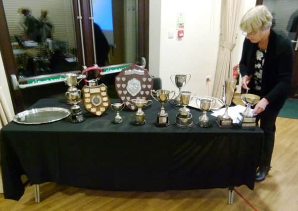 Organising the trophies for Mundham and District Gala and Flower Show's annual meeting