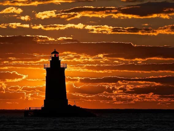 A dramatic sunset in Lewes, Delaware, USA. The town is home to several impressive lighthouses and a lightship is a visitor attraction in the harbour.