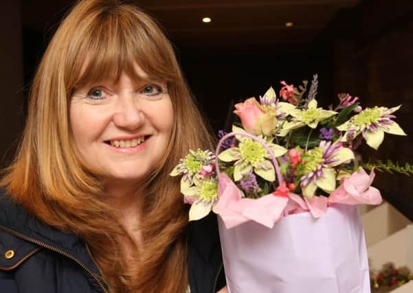 Jayne Pumfrey with her third prize winning floral art. Photo by Derek Martin DM16150774a