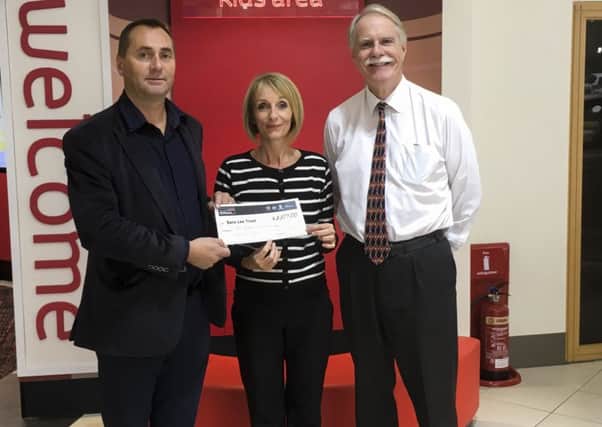 Michael Lear (Business Ambassador) for the Sara Lee Trust receives  a cheque for ?3,107 from SLM Toyota Group MD Ian Wakeford  and Mel Ball (Marketing Manager). SUS-160211-124616001