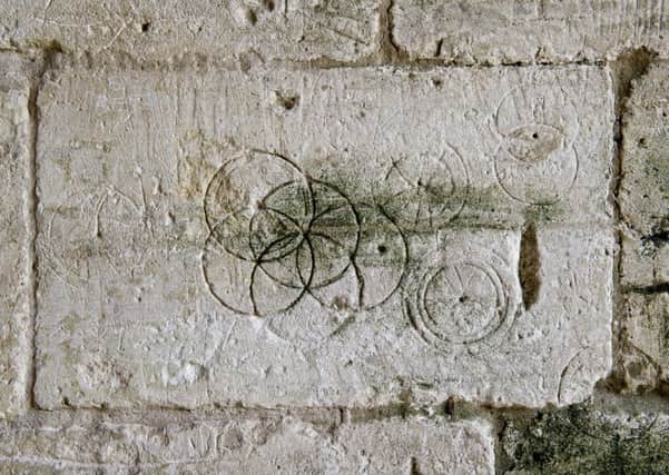 Daisy-Wheels inscribed with a pair of compasses or dividers found in Saxon Tithe barn, Bradford-on-Avon. Picture: Historic England