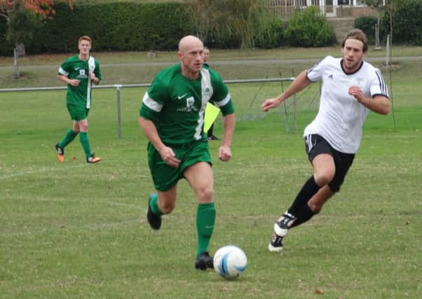 Stuart Garrod travels with the ball during Saturday's clash at Bexhill United. Picture: Simon Newstead