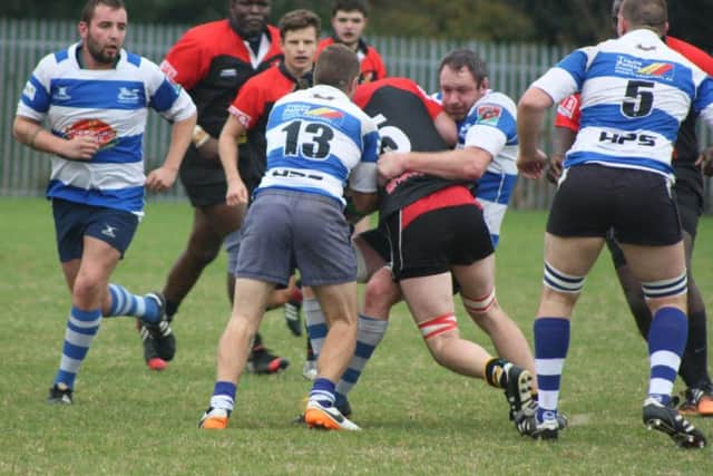 Hastings & Bexhill captain Jimmy Adams wraps up a Southwark Lancers opponent. Picture courtesy Karen Walker