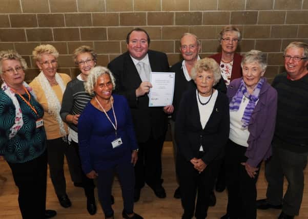 Crawley Borough Council cabinet member for community and engagement Michael Jones presents Â£750 to the Come and Meet Each Other (CAMEO) group - picture submitted by CBC