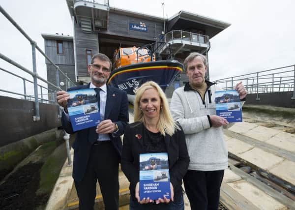 Lifeboat operations manager Peter Huxtable, left, with authors Michelle Tugwell and John Periam at Shoreham Harbour Lifeboat Station
