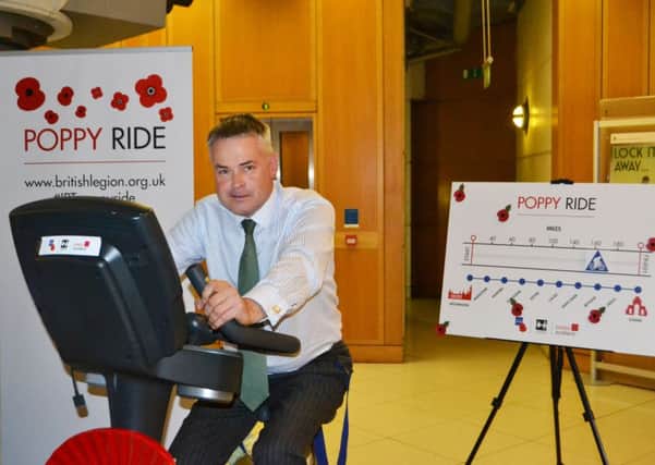 East Worthing and Shoreham MP Tim Loughton racde against the clock on an exercise bike to raise money for The Royal British Legions annual Poppy Appeal.