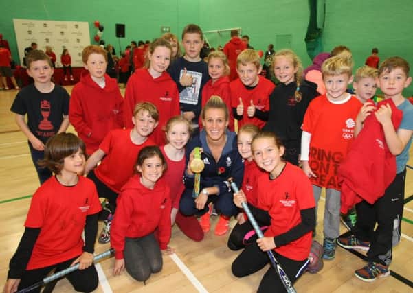 Alex Danson is pictured with members of the Chichester Westgate Triathlon Club