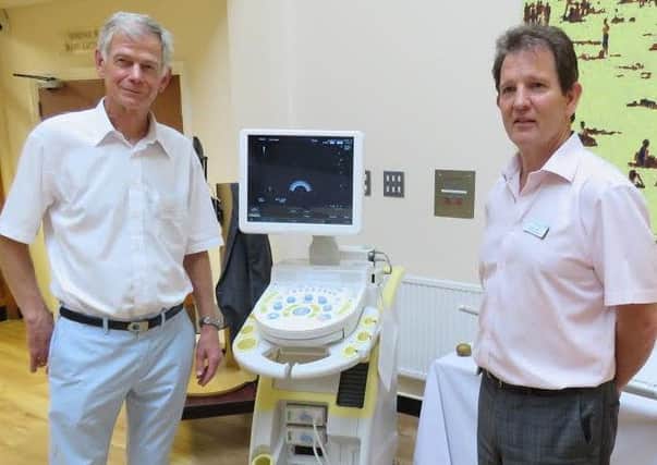 Jim Robertson with St Richard's consultant Paul Carter and the scanner