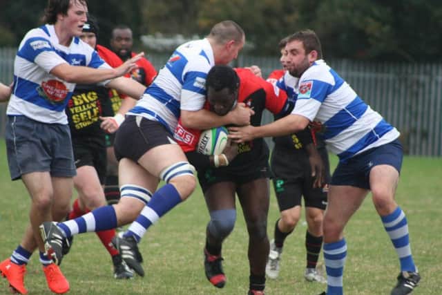 Two H&B players tackle a Southwark Lancers opponent. Picture courtesy Karen Walker