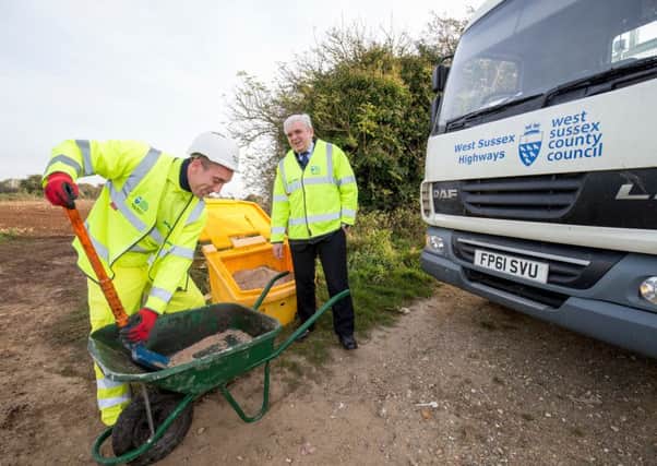 Bob Lanzer, West Sussex County Council's cabinet member for highways and transport watching a grit bin being filled SUS-160711-163221001