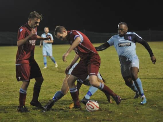Lewis Hole in the thick of the action for Little Common against AFC Uckfield Town. Picture by Simon Newstead