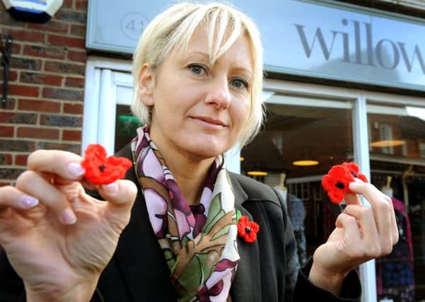Jo Knight outside her Billingshurst shop where a charity box for the Poppy Appeal was stolen. Pic Steve Robards   SR1633560 SUS-160911-133641001