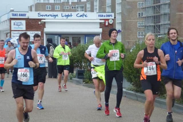 Runners head east along Bexhill seafront in the 2015 Poppy Half Marathon.