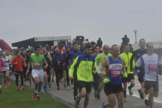 Runners battled wind and rain on Bexhill seafront on Saturday. Picture by Simon Newstead