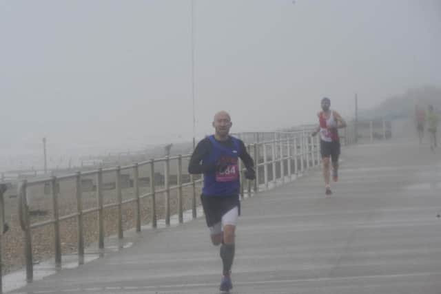 Poppy Half Marathon winner Alan Silvester battles through the rain and wind. Picture by Simon Newstead