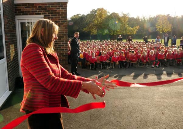Children watch as the Duchess of Norfolk cuts the ribbon to open the new classrooms at Arundel CofE School. Picture: Kate Shemilt