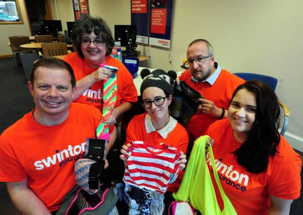 Staff at Swinton Insurance in Bognor Regis with some of the donated clothes. Picture: Kate Shemilt ks16001169-1