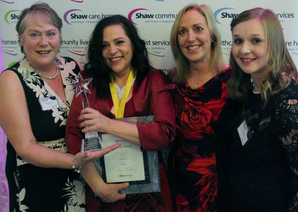 Hillside Lodge team leader Delia Giles celebrates her Happiness Award win with other staff