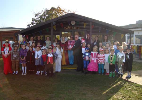 Burstow Primary School pupils and staff dress up as book characters as Horley town mayor Mike George opens their new library, The Pavilion - submitted